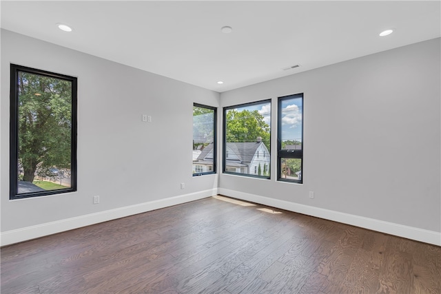 unfurnished room with dark hardwood / wood-style flooring