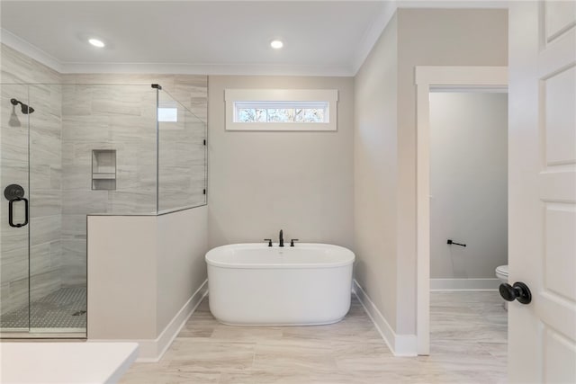 bathroom with ornamental molding, separate shower and tub, and toilet