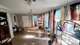 interior space featuring ceiling fan and crown molding