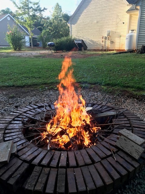 view of yard with a fire pit