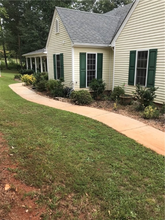 view of side of home with a lawn