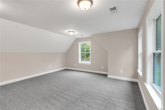 bonus room featuring lofted ceiling and carpet flooring