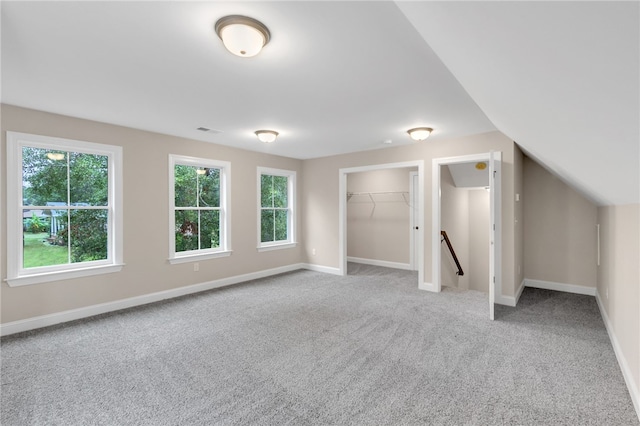 bonus room with carpet floors and vaulted ceiling