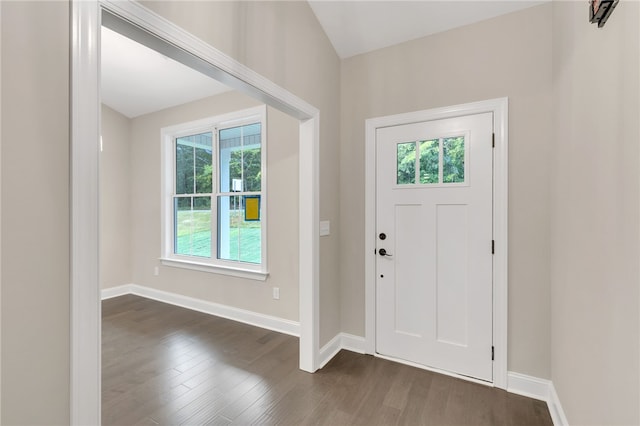 foyer entrance featuring dark wood finished floors and baseboards