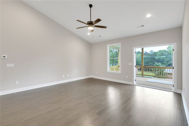 empty room with ceiling fan, dark hardwood / wood-style floors, and vaulted ceiling