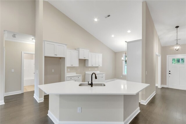 kitchen with a healthy amount of sunlight, high vaulted ceiling, a kitchen island with sink, and sink