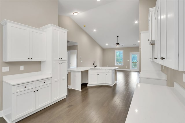 kitchen featuring white cabinetry, sink, vaulted ceiling, dark wood-type flooring, and ceiling fan