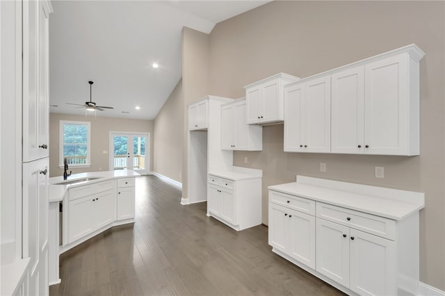 kitchen featuring french doors, dark wood-type flooring, sink, ceiling fan, and white cabinetry