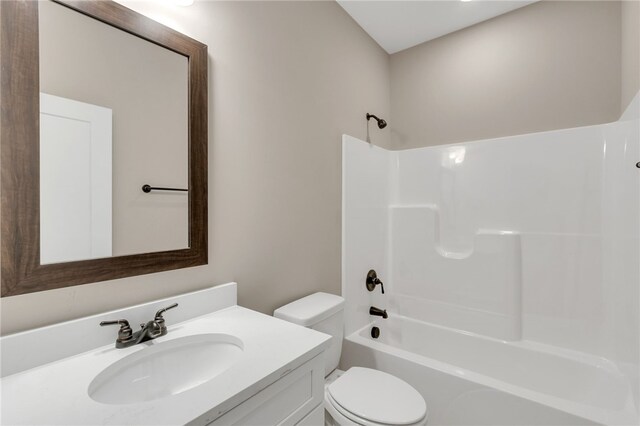 full bathroom with vanity, tub / shower combination, and toilet