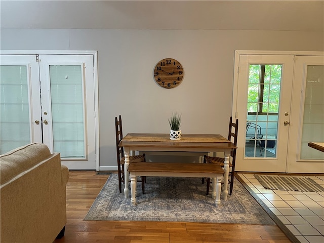 dining area featuring wood-type flooring and french doors