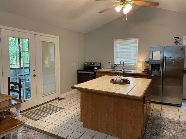 kitchen with black electric range, sink, a center island, and stainless steel fridge with ice dispenser