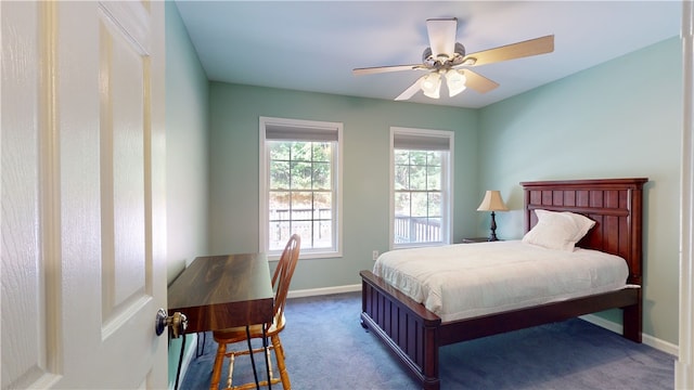 bedroom with dark colored carpet and ceiling fan