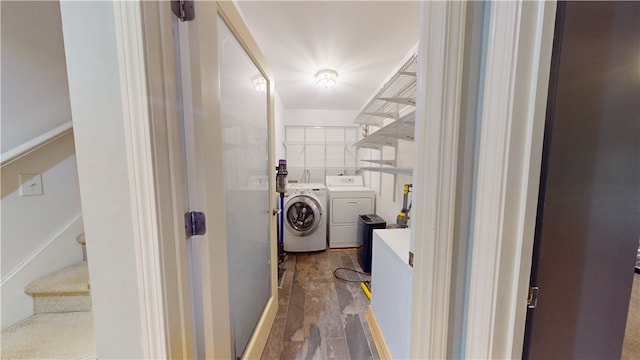 laundry area with dark hardwood / wood-style floors and washing machine and dryer