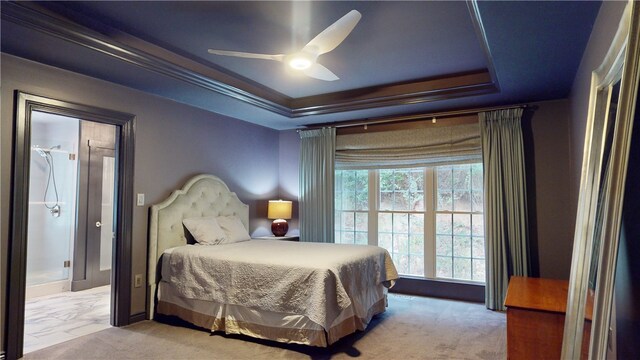 carpeted bedroom featuring a raised ceiling, ceiling fan, and ornamental molding