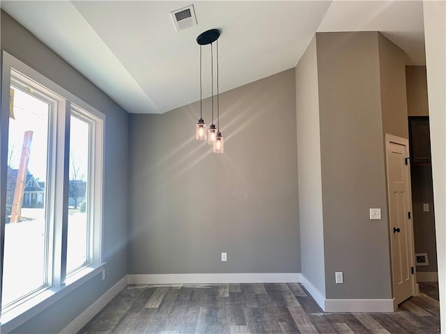 unfurnished dining area with a healthy amount of sunlight, dark hardwood / wood-style flooring, and vaulted ceiling