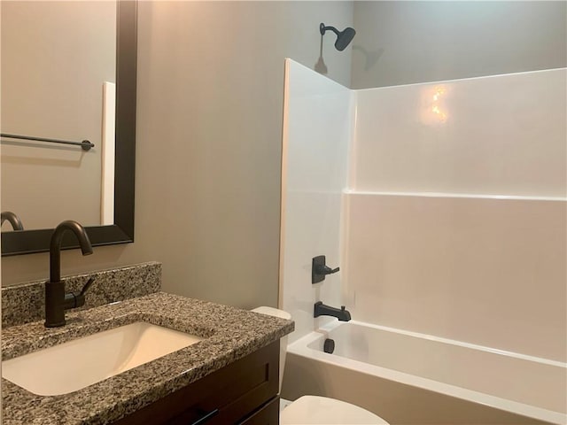 bathroom with toilet, vanity, and shower / tub combination