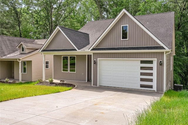 156 Grand Oak Cir, Pendleton, SC 29670 - view of front of property featuring an attached garage, a shingled roof, driveway, and central AC unit