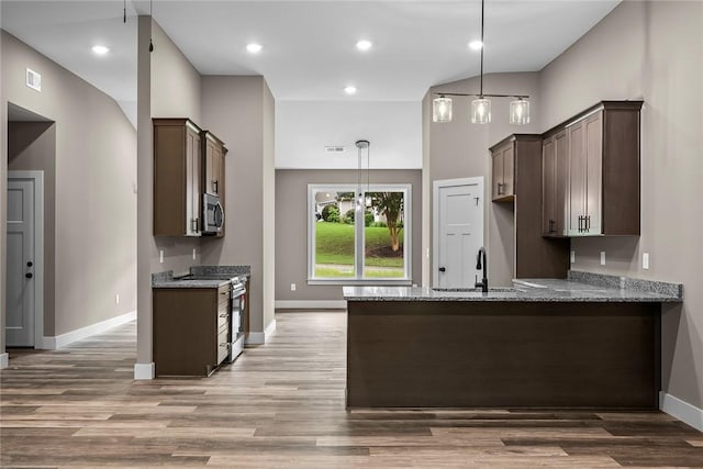 156 Grand Oak Cir, Pendleton, SC 29670 - kitchen featuring dark brown cabinetry, a sink, light stone counters, a peninsula, and stainless steel appliances