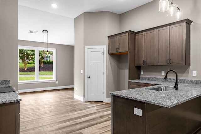 156 Grand Oak Cir, Pendleton, SC 29670 - kitchen with light stone counters, pendant lighting, a sink, and light wood-style floors