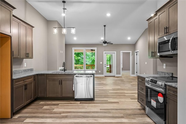 156 Grand Oak Cir, Pendleton, SC 29670 - kitchen with appliances with stainless steel finishes, light stone countertops, light wood-type flooring, a sink, and a peninsula