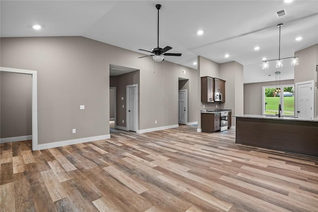 156 Grand Oak Cir, Pendleton, SC 29670 - unfurnished living room featuring visible vents, a sink, light wood-style floors, and vaulted ceiling