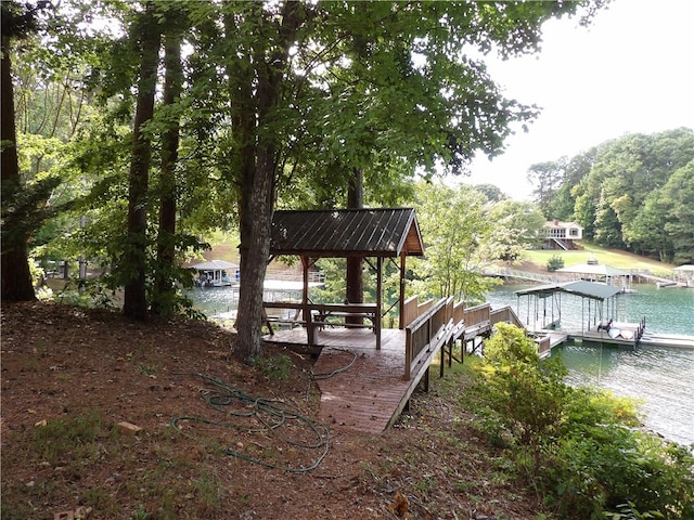 dock area featuring a deck with water view