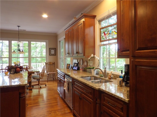 kitchen with pendant lighting, crown molding, light hardwood / wood-style flooring, and a healthy amount of sunlight