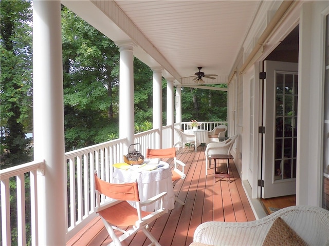 wooden terrace with a porch and ceiling fan