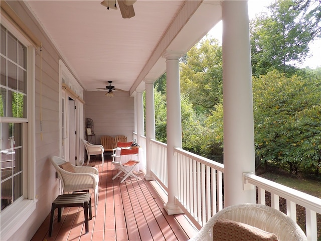 balcony with a porch and ceiling fan