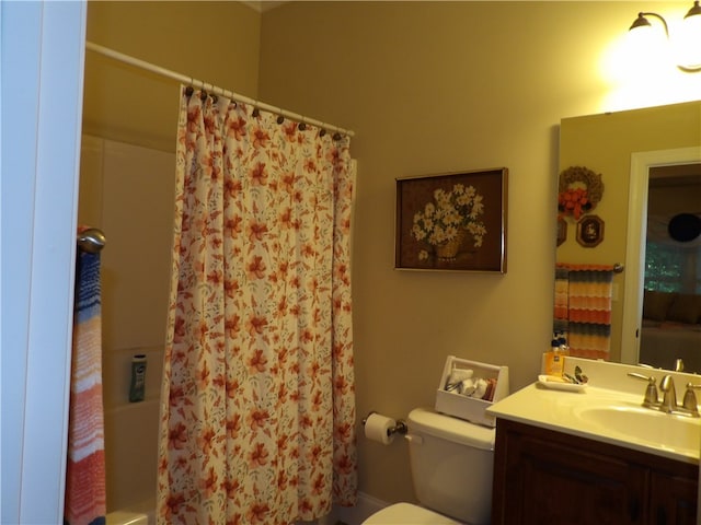 full bathroom with shower / bath combo, vanity, and toilet