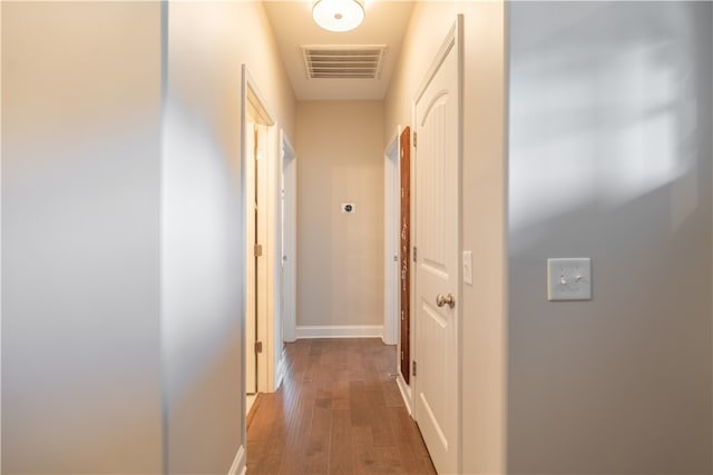 hall with dark hardwood / wood-style flooring