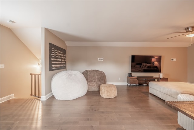 living room featuring hardwood / wood-style floors and ceiling fan