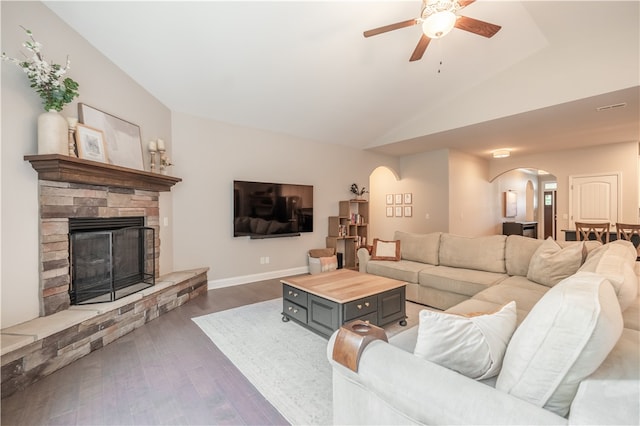 living room with ceiling fan, lofted ceiling, dark hardwood / wood-style floors, and a fireplace