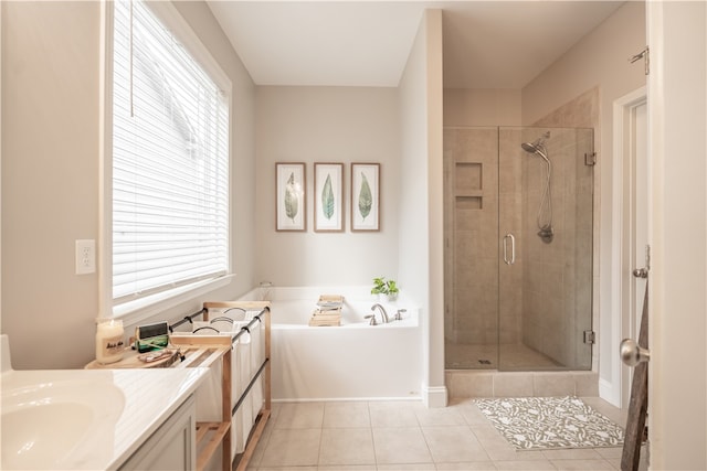 bathroom featuring shower with separate bathtub, tile patterned floors, a healthy amount of sunlight, and vanity