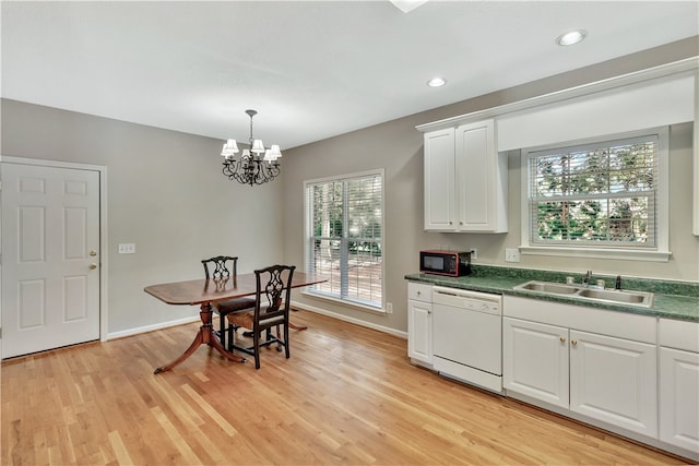 kitchen featuring pendant lighting, sink, white cabinetry, dishwasher, and light hardwood / wood-style floors