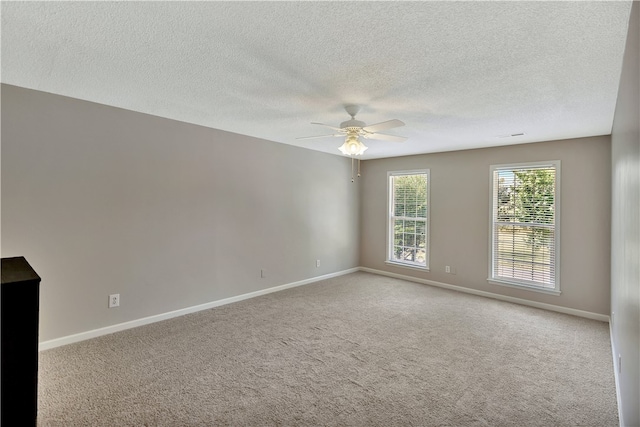 carpeted empty room featuring a textured ceiling and ceiling fan