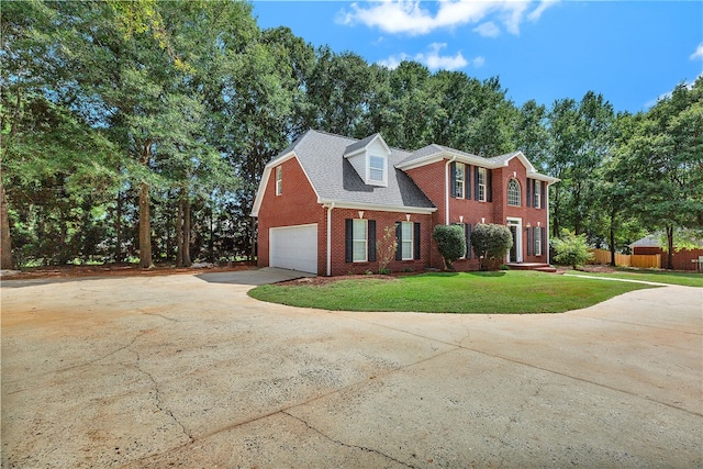 view of front facade featuring a garage and a front lawn