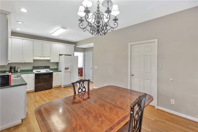 dining room featuring light hardwood / wood-style floors and an inviting chandelier