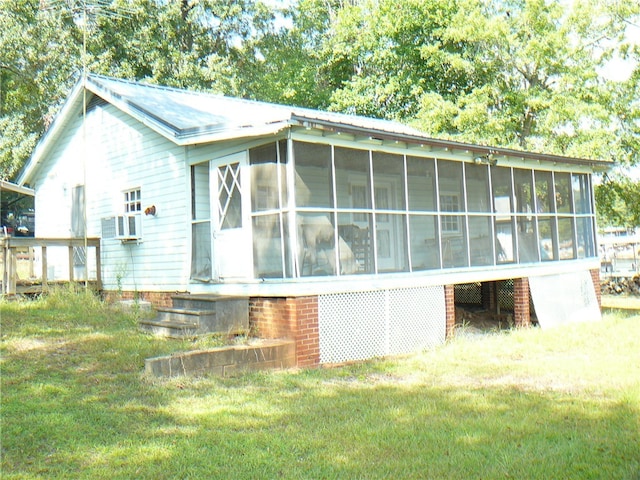 view of side of home featuring a yard and a sunroom