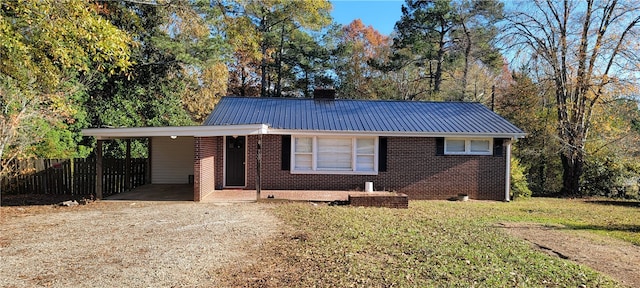 ranch-style house featuring a carport and a front lawn