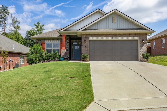 craftsman house with a front yard and a garage