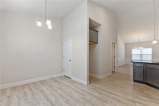 interior space with an inviting chandelier, light wood-type flooring, and high vaulted ceiling