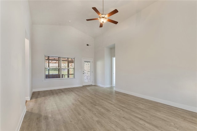 unfurnished living room featuring light hardwood / wood-style floors, ceiling fan, and high vaulted ceiling