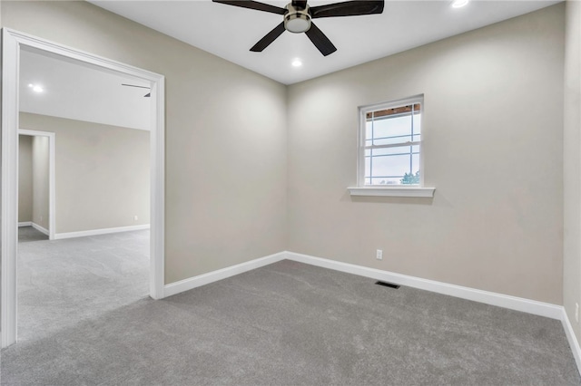 spare room with light carpet and ceiling fan