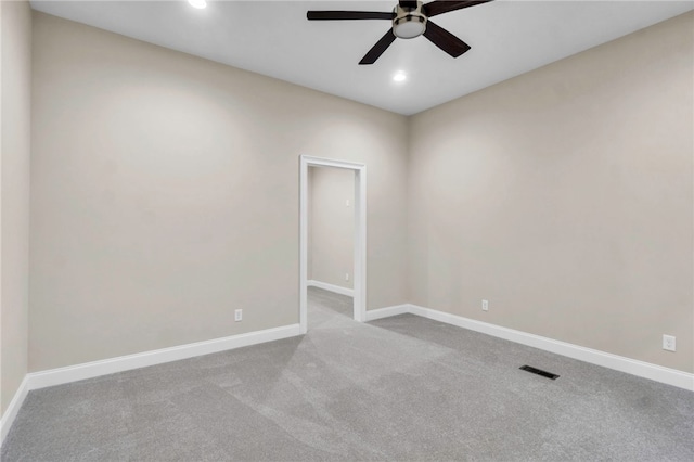 spare room featuring ceiling fan and light colored carpet