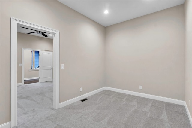 carpeted spare room with ceiling fan