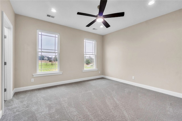 carpeted empty room featuring ceiling fan