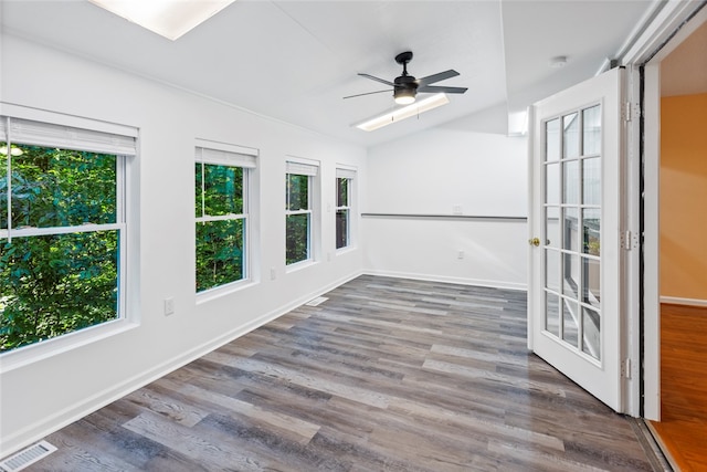 unfurnished sunroom featuring ceiling fan