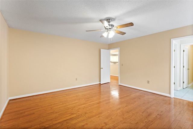 unfurnished room featuring ceiling fan, a textured ceiling, and light hardwood / wood-style floors