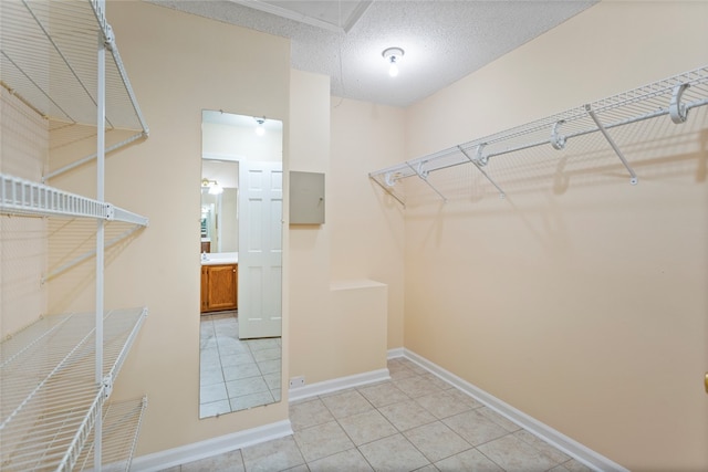 spacious closet with light tile patterned floors